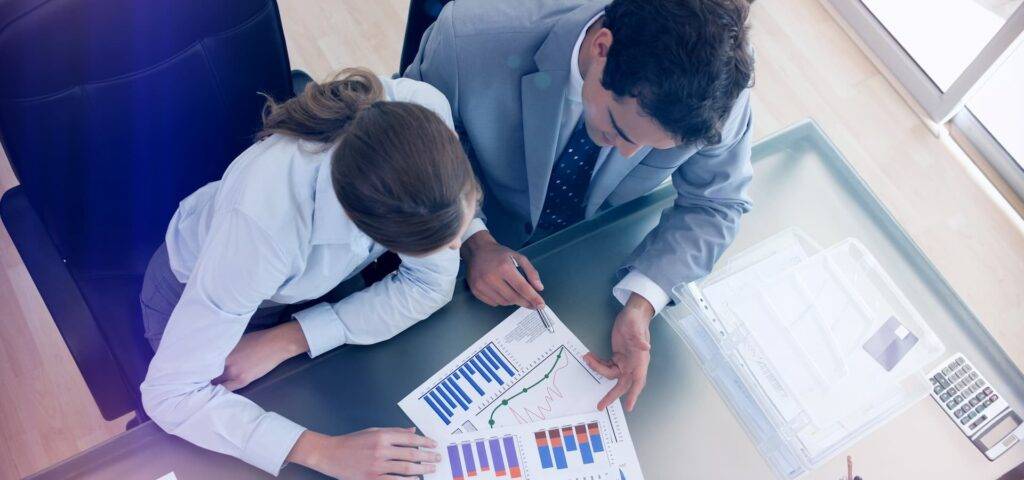 Above view of consultant analyzing data with her client